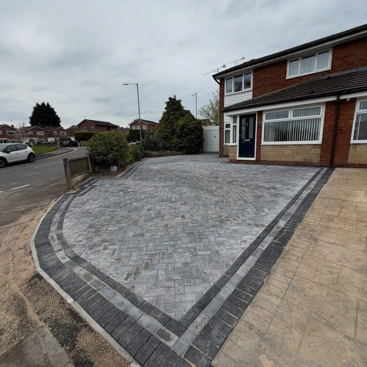 Block paved driveway with a curved border