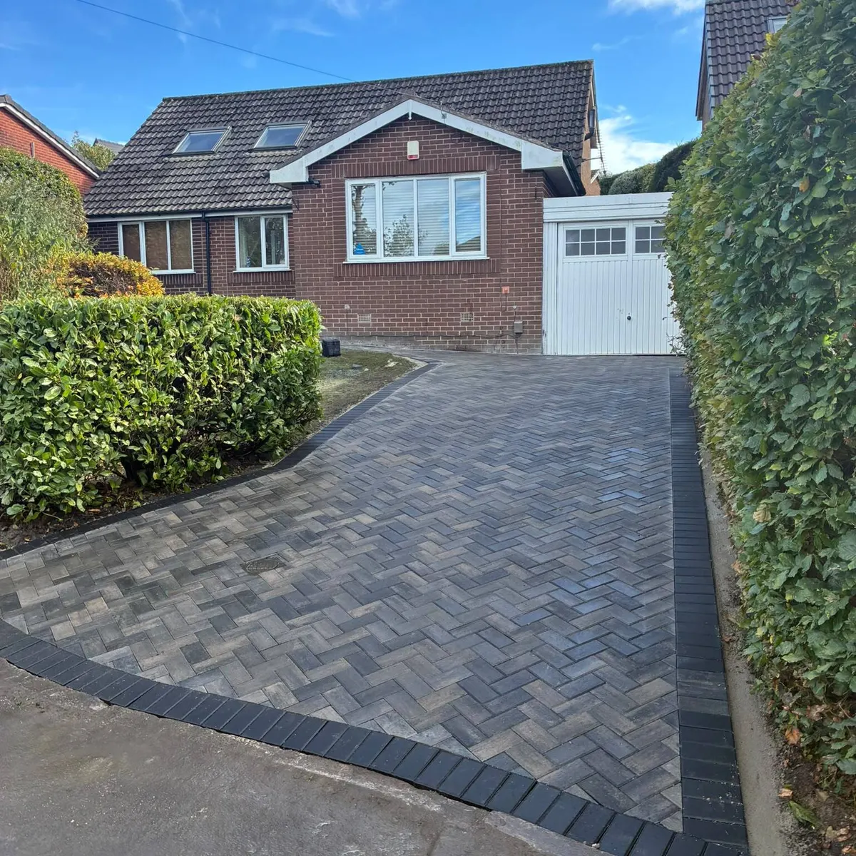 After: herringbone block paved driveway with a charcoal border