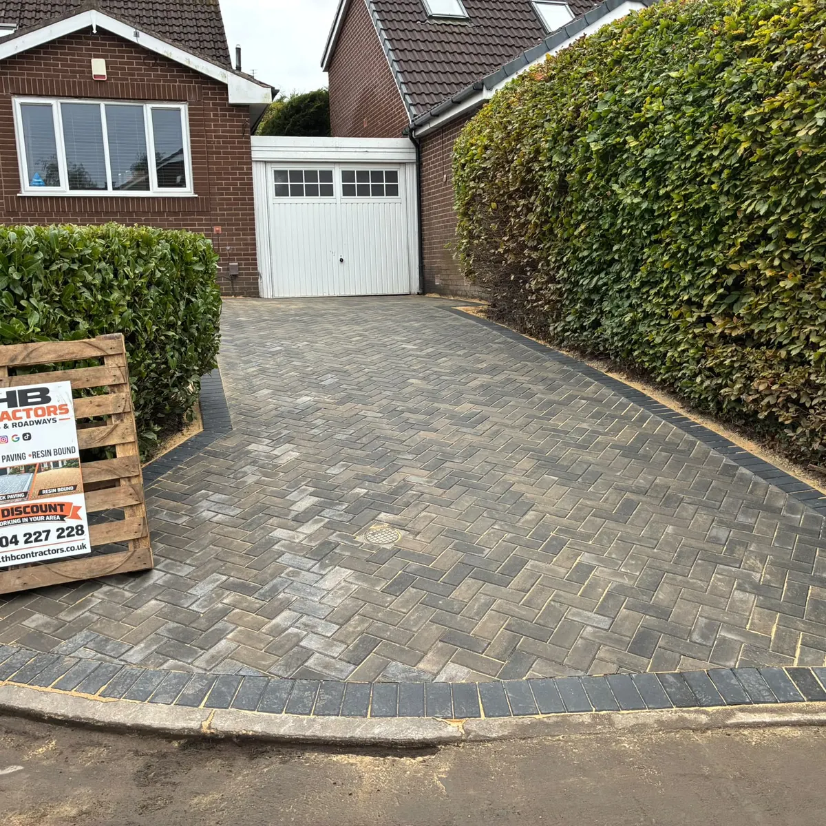 After: the same driveway in herringbone block paving with a charcoal border