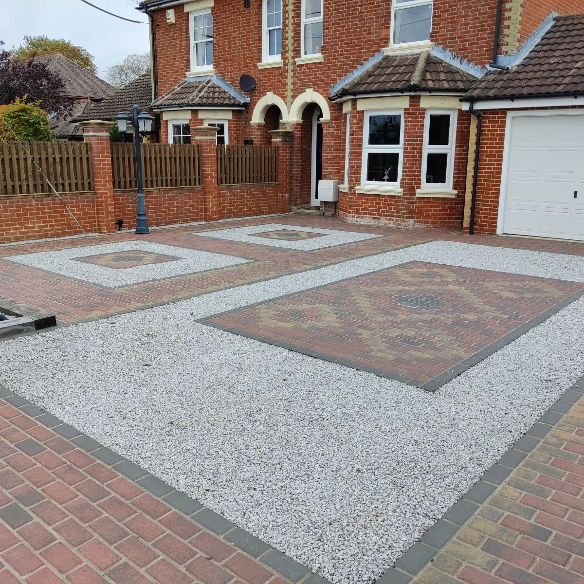 Gravel driveway with block-bordered bays
