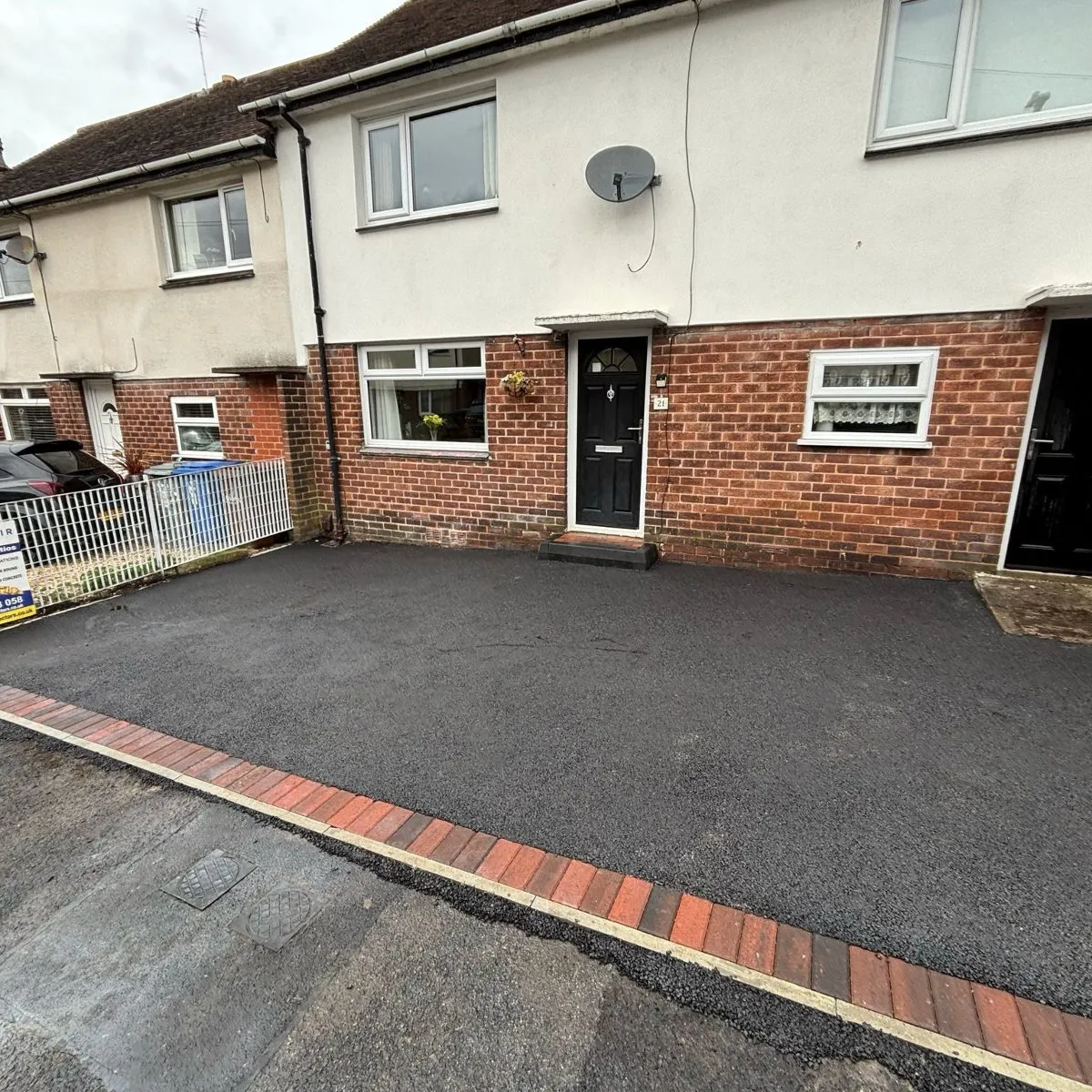 Tarmac driveway with a brick border