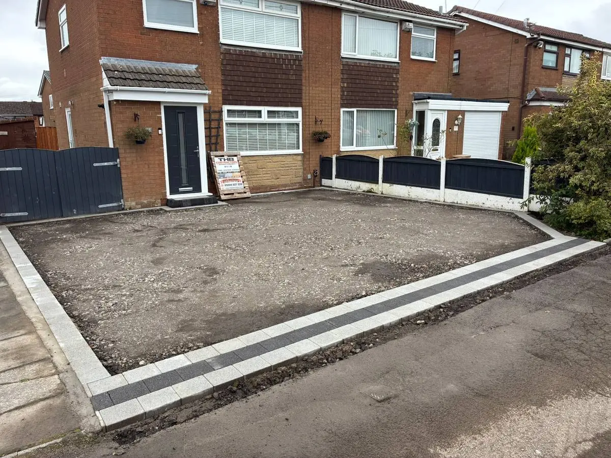 During: sub-base prepared and the silver and charcoal block edging laid