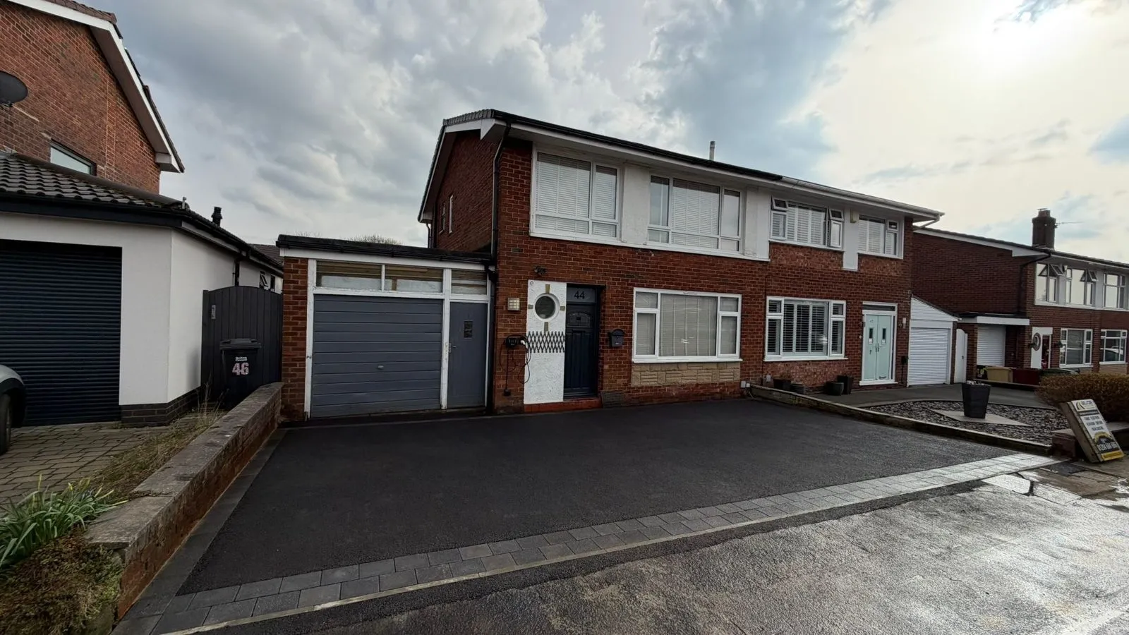 A completed tarmac driveway at a semi-detached home