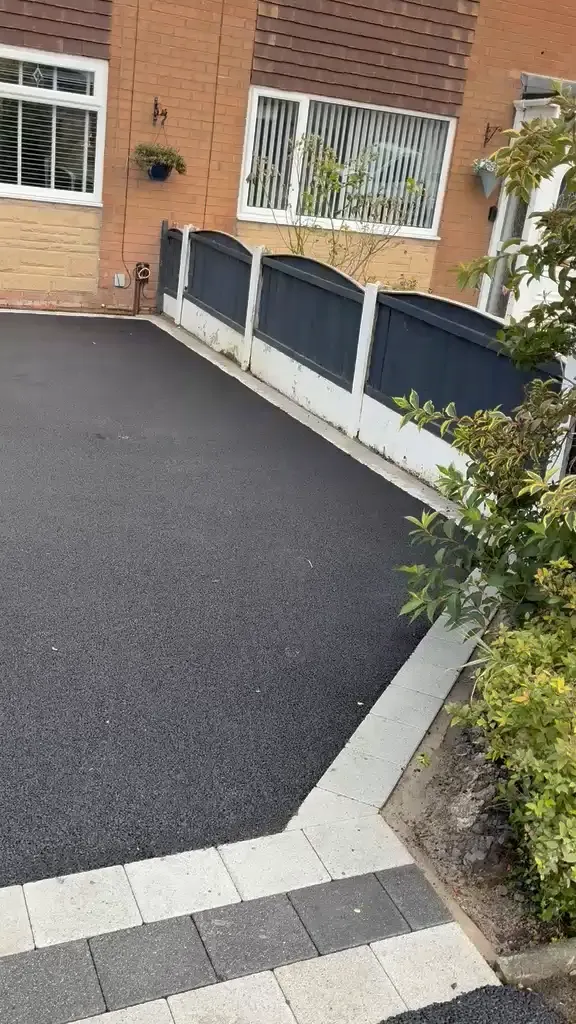 Finished tarmac driveway with a silver and charcoal block border